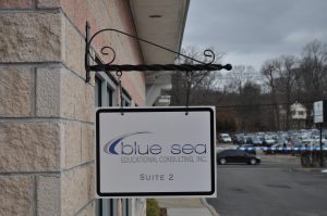 Goldsboro Wayfinding Signs outdoor hanging blade sign blue sea building business wayfinding address sign 300x199